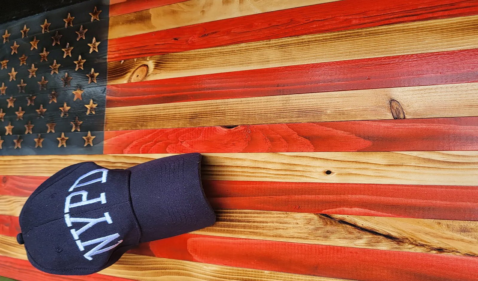 Red and natural wooden flag with NYPD cap